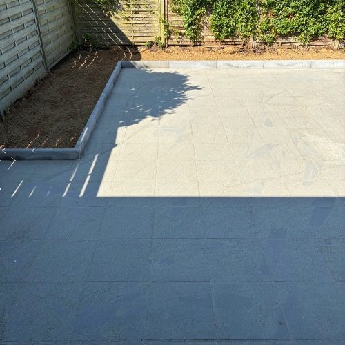 Terrasse ved hus med stilfuld flisebelægning